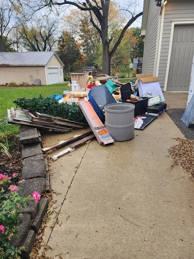 Dumpster being loaded with debris for Roofing Dumpster Rental in Dansville